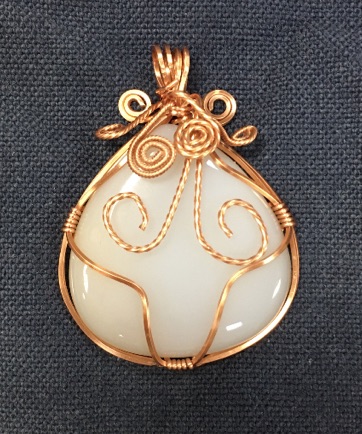 White cabochon wrapped with gold wire by Joy Lester for HGMS Beginning Wire Wrapped Pendant Class