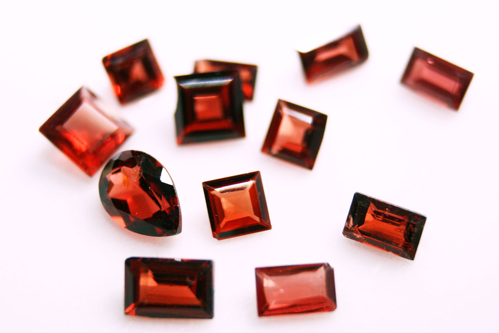 deep red garnet gemstones in princess, emerald and teardrop cuts