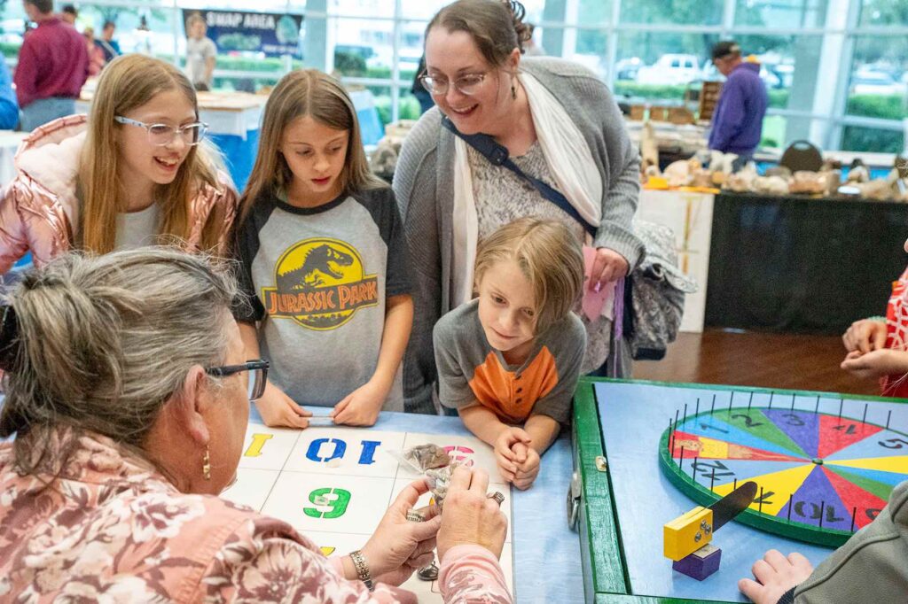 Libby Guynn and customers at Youth Section Table