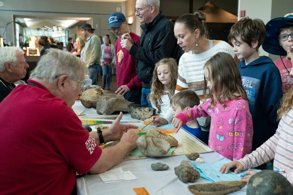 Neal Immega and Clyde McMeans and customers at Paleo Table